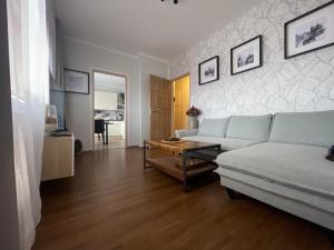 a living room with a couch and a table at Andel apartment with terrace in Prague