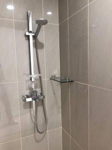 a shower with a shower head in a bathroom at Batam Luxurious, Breezy 1 bedroom! in Nongsa