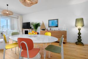 a dining room with a white table and chairs at Olbia Luxury Apartment in Olbia