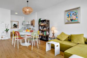 a living room with a couch and a table and chairs at Olbia Luxury Apartment in Olbia +25 photos