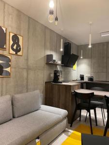 a living room with a couch and a kitchen at Downtown Chic 2 in Iaşi