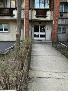 a sidewalk leading to a building with a door at Downtown Chic 2 in Iaşi