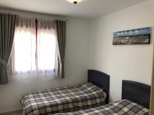 a bedroom with two beds and a window at Amatista 11 a in Calpe