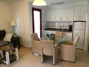 a kitchen and dining room with a glass table and chairs at Amatista 11 a in Calpe