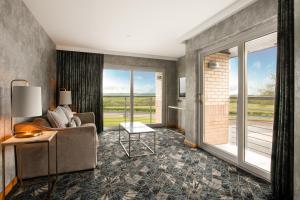 a living room with a couch and a table at Radstone Hotel in Larkhall