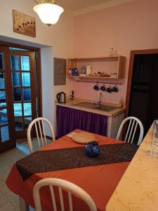 a kitchen with a table and a kitchen with a sink at Cesare Battisti in Seggiano