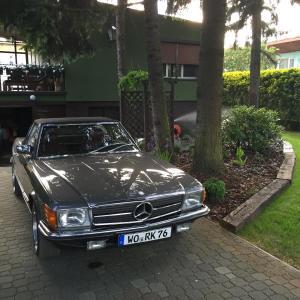a black car parked in front of a house at Pod Świerkami in Boszkowo