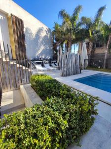 a house with a swimming pool and some chairs and trees at Sciara Biscari B&B in Catania