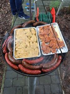 a grill with sausage and other food on it at Pod Świerkami in Boszkowo