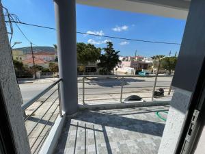 a view of a street from a balcony at AVR Airport Deluxe Suites 6 in Markopoulo