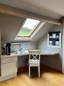 a kitchen with a table and a window at La Borzeux in Stavelot
