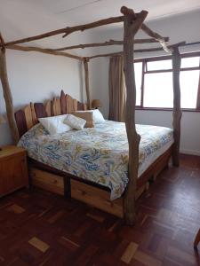 a bedroom with a bed with a wooden frame at Beach dream in Fish Hoek