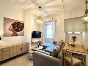 a living room with a couch and a table at Nenas Volto Apartment in Corfu