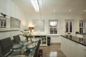 a dining room with a glass table and a kitchen at Your Home from Home - River bank 