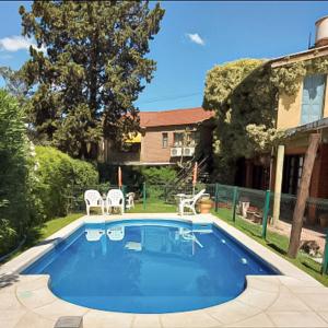a swimming pool in the backyard of a house at POSADA NEHUEN in Villa General Belgrano