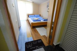 a small room with a bed and a window at LM Rooms in Banja Luka