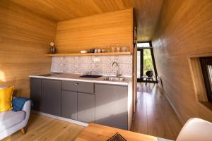 a kitchen with a sink and a counter top at PortusHome Vászoly in Vászoly