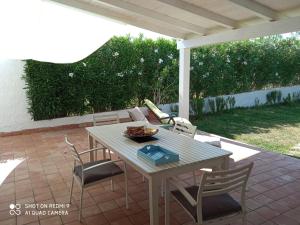 a table and chairs sitting on a patio at Villa Amenta in Fontane Bianche +19 photos