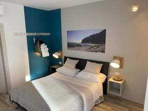 a bedroom with a bed and a blue wall at B&B 125Metri sul mare in Sirolo