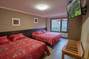 a hotel room with two beds and a window at Mirabosque New Apartments 3 in Osorno