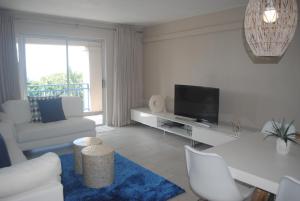 a living room with a couch and a television at 65 Key Largo in Kingsburgh