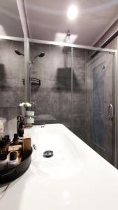 a bathroom with a shower and a white sink at Skopea Inn Exclusive Hotel in Göcek