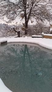 a swimming pool with snow on top of it at Agriturismo Cascina Knec in Feisoglio