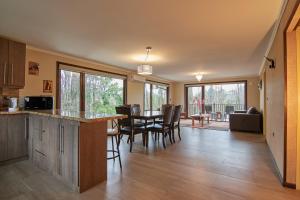 a kitchen and dining room with a table and chairs at Mirabosque New Apartments 1 in Osorno