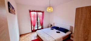 a bedroom with a bed and a window at Umago Inn in Umag