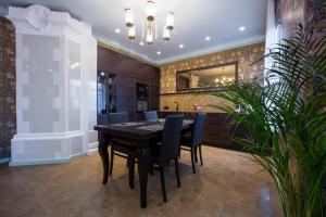 a dining room with a black table and chairs at Amber House in Liepāja