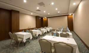 a conference room with white tables and chairs at Liv City Hotels in Istanbul