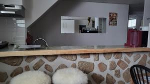 a kitchen with a counter with a mirror at Private trendy studio with fireplace in Ottawa