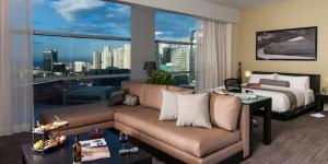 a living room with a couch and a bed at Stadia Suites Mexico City Santa Fe in Mexico City +42 photos
