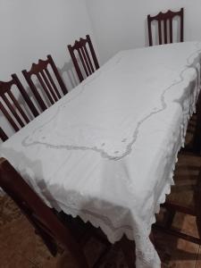a table with a white table cloth on it at Casa com piscina Temporada Foz do Iguaçu in Foz do Iguaçu