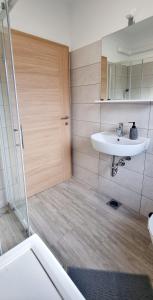 a bathroom with a sink and a shower at Umago Inn in Umag
