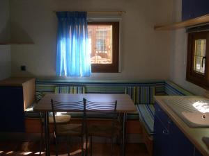 a kitchen with a table and chairs and a window at L'Oasi di Lulu' in Senigallia