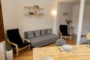 a living room with a couch and two chairs and a table at Suite Alhambra Puerta Bib-Rambla in Granada