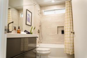 a bathroom with a toilet and a sink and a shower at Cheerful 2bedroom home with hot tub and cowboy pool in Joshua Tree in Joshua Tree