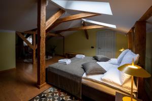a large bed in a room with wooden beams at Amber House in Liepāja