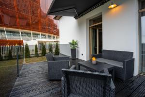 a patio with a table and chairs and a building at Amber House in Liepāja