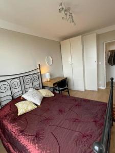 a bedroom with a large bed with a red blanket at Apartament Pomarańczowy in Warsaw