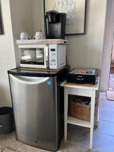 a microwave sitting on top of a small refrigerator at The Midtown Cottage- w/ Private Entrance and Views in Santa Cruz