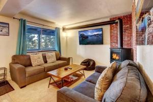 a living room with a couch and a fireplace at Spacious Lakeview Heavenly Mountain Escape! in Stateline