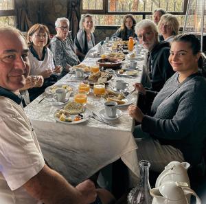 a group of people sitting around a table eating food at Riad Chay & Boutique in Ouarzazate
