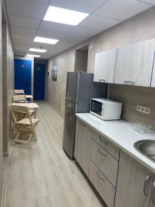 a kitchen with a refrigerator and a sink at Hostel GARDEN St in Odesa +28 photos