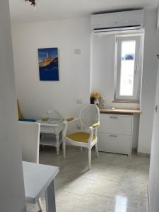 a kitchen with a table and chairs in a room at Longano 35 in Capri