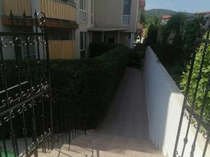 a stairway leading up to a building with a hedge at Tedi in Kranevo