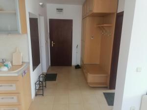 a hallway of a kitchen with a sink and a door at Tedi in Kranevo