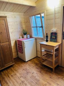 a kitchen with a refrigerator and a table in a room at Chatky Daniel-Mikulov, a private campsite just for you in Mikulov