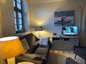 - un salon avec un canapé et une télévision dans l'établissement Bürgerhaus Langenberg, à Velbert